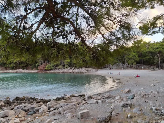 A small sandy harbour bay at Phaselis on the Lycian coast, with pine trees and mountains behind